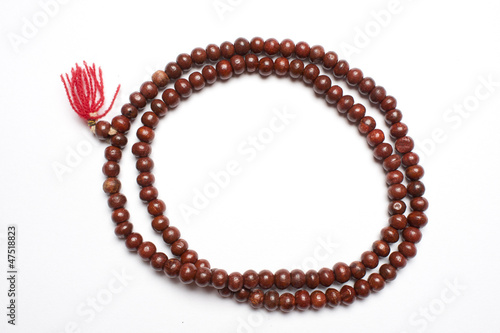 Prayer beads made from sandalwood in a white background