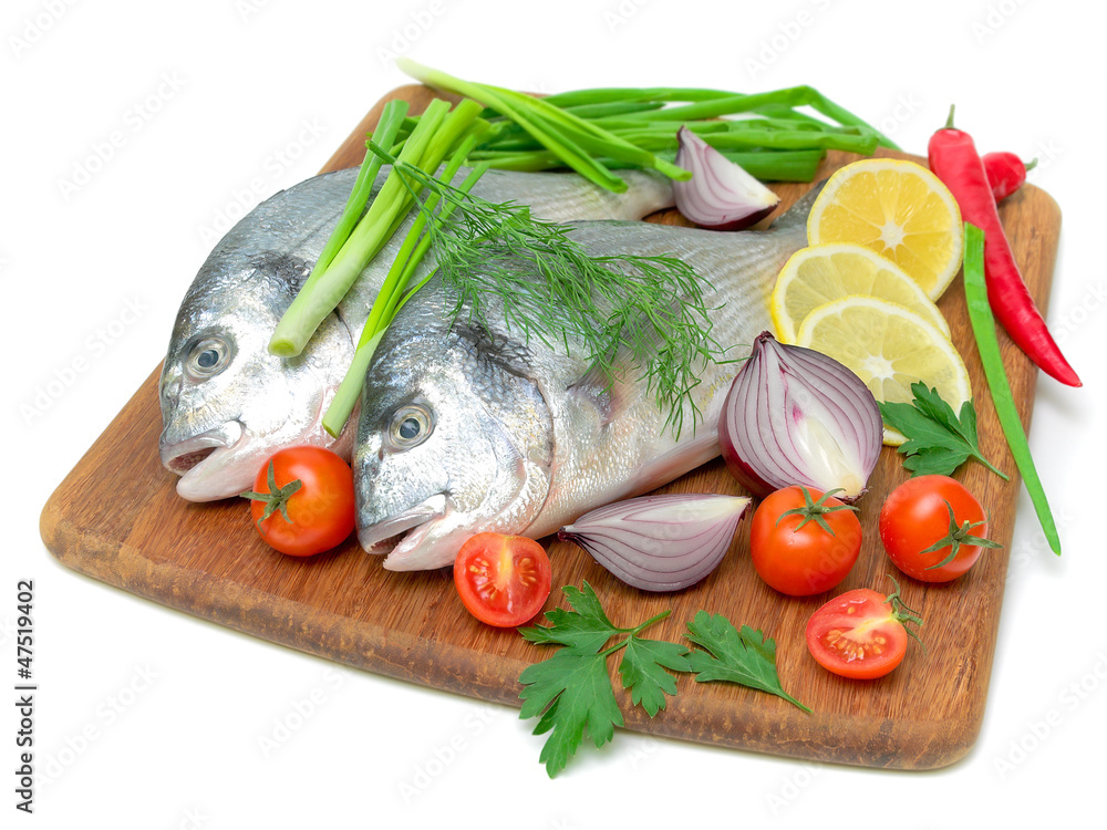 Dorado fish and vegetables on white background Dorado fish and vegetables on white background