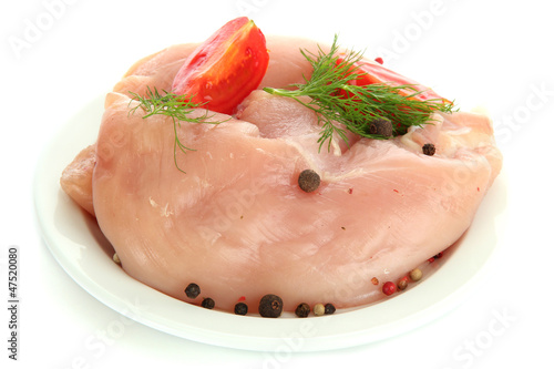 raw chicken meat with spices on plate, isolated on white