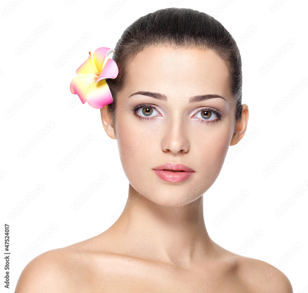 Beauty face of young woman with flower. Beauty treatment concept Beauty face of young woman with flower. Beauty treatment concept