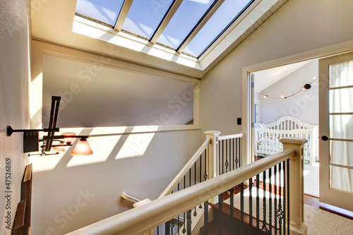 Staircase with skylight and baby room.