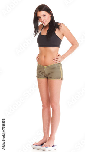 Weight loss woman on scale unhappy © Voyagerix