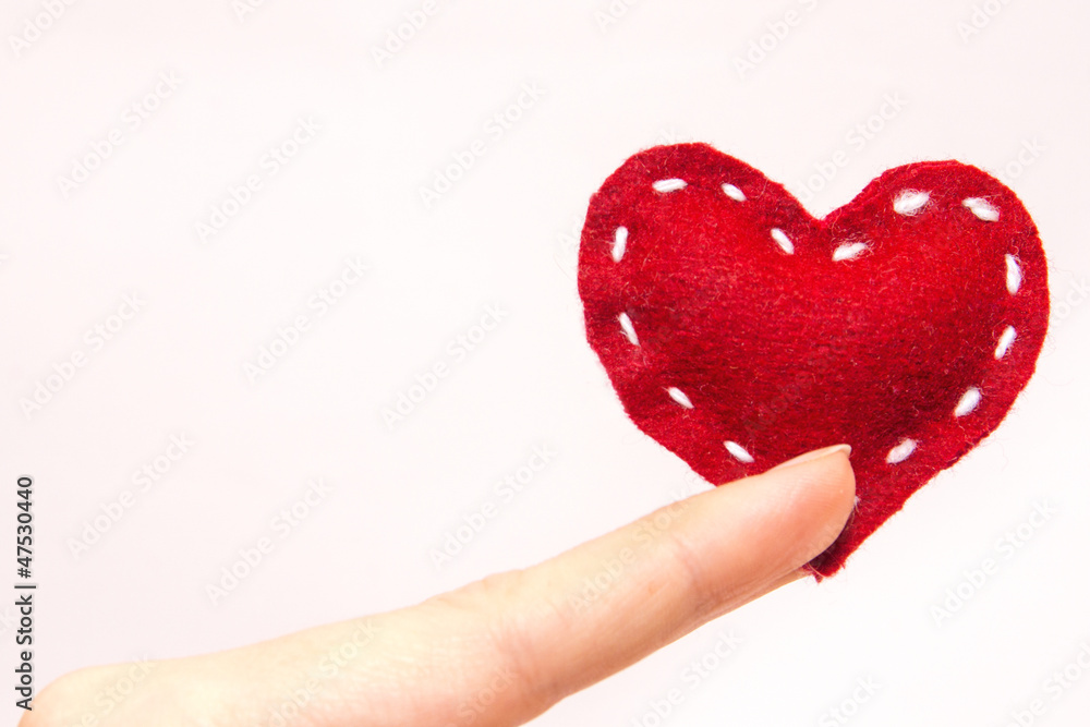 Fototapeta premium Red heart in fingers