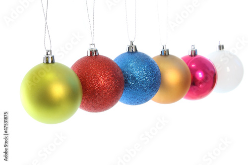 Multiple hanging Christmas ball on white background.
