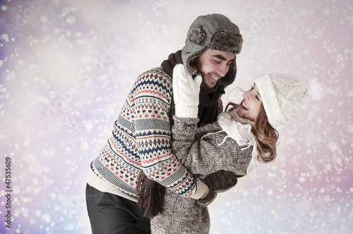 Happy funny couple  covering  snow background.  Fool around photo