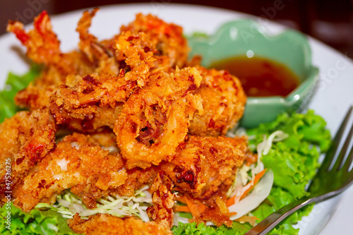 Deep fried squid rings on the plate with salad