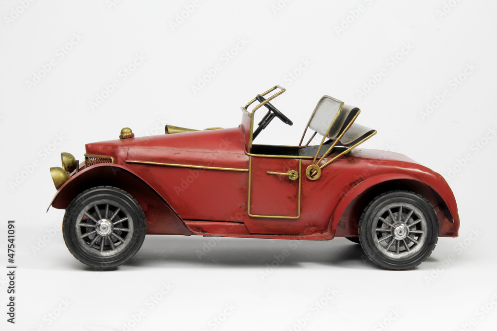 Red vintage model of car isolated on white