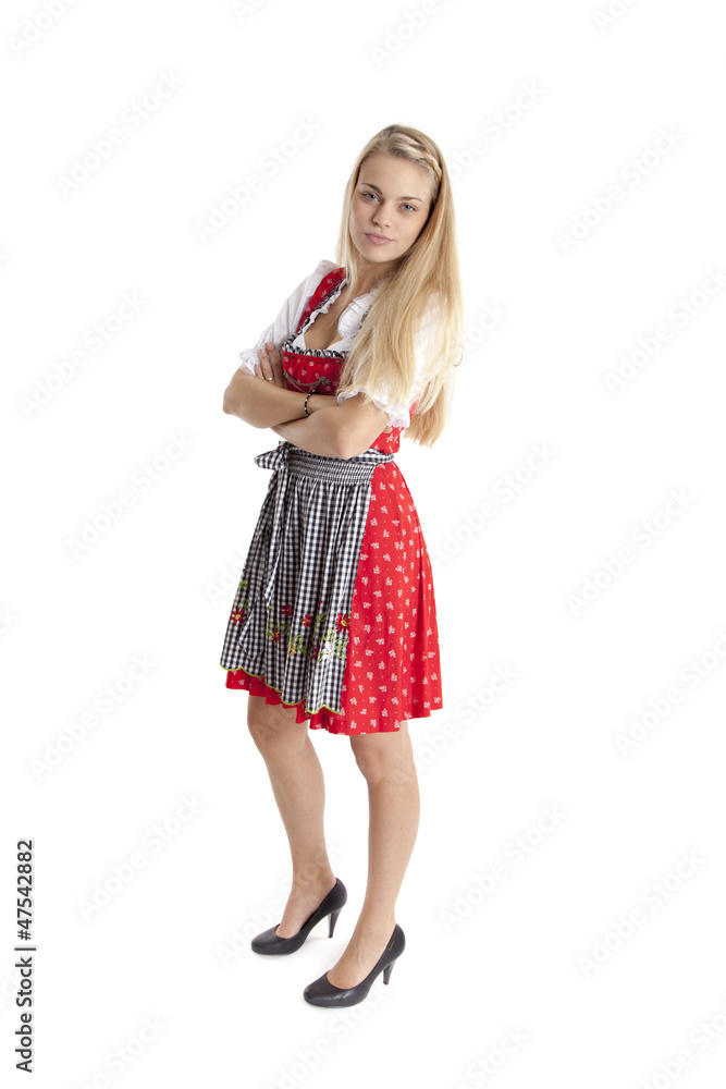Blonde Frau im Dirndl verschränkt die Arme. Blonde Frau im Dirndl verschränkt die Arme.