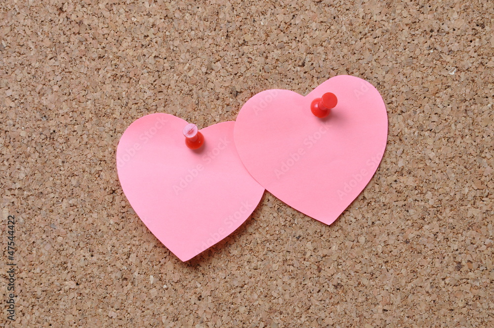 Pin board with piece of paper in the shape of heart Pin board with piece of paper in the shape of heart