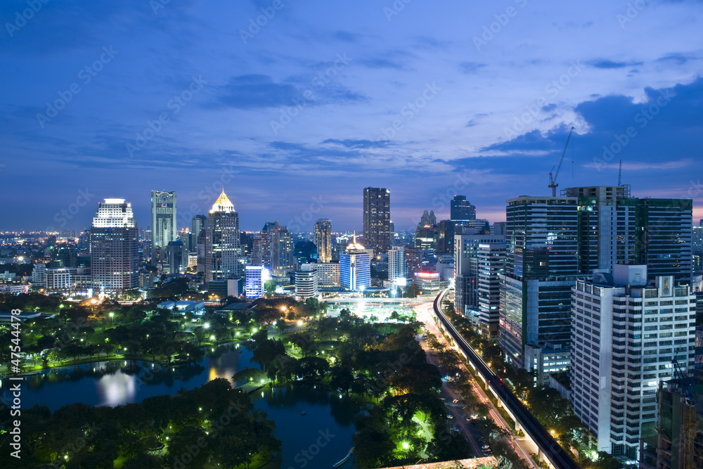 Fototapeta premium Business tower area with sky train and park foreground