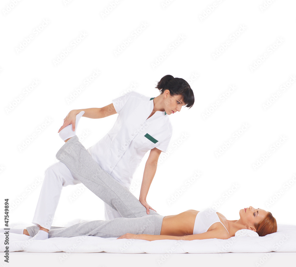 A young redhead woman getting a traditional Thai massage A young redhead woman getting a traditional Thai massage