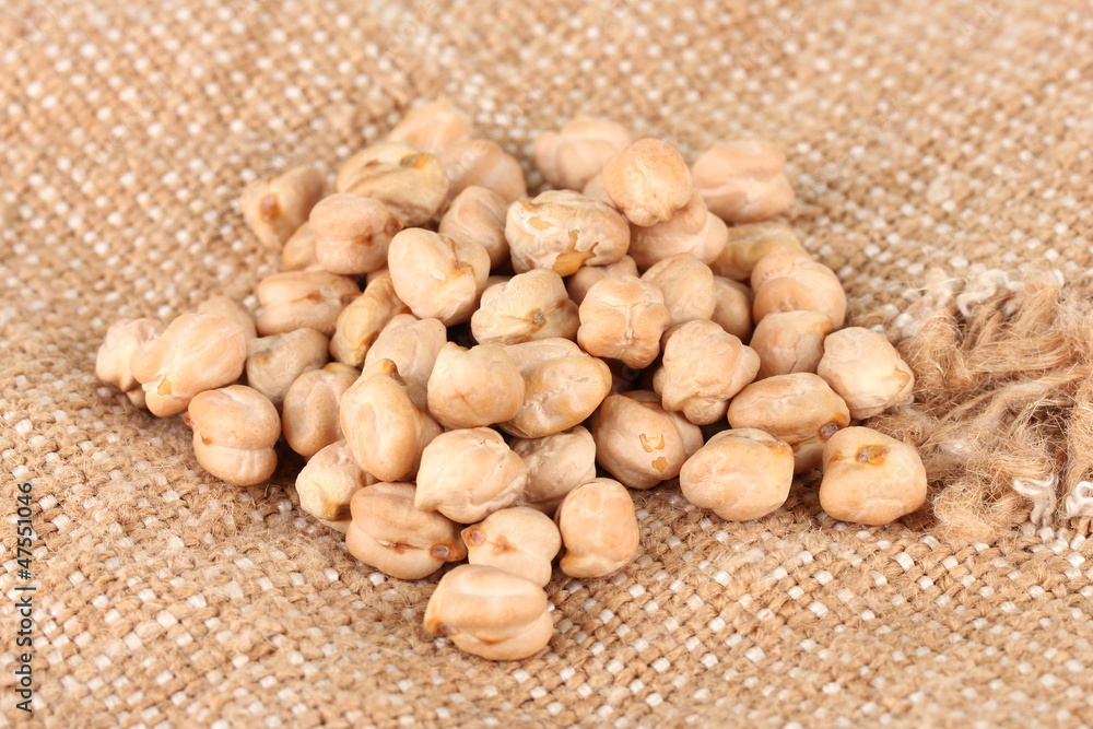 White chickpeas on sackcloth background White chickpeas on sackcloth background