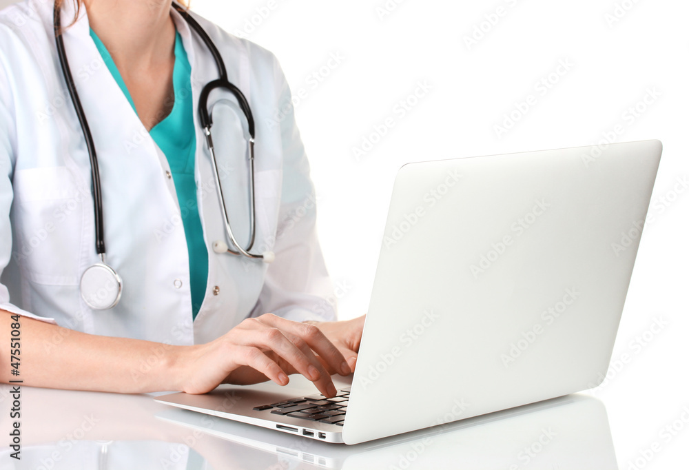 Doctor using laptop computer isolated on white Doctor using laptop computer isolated on white
