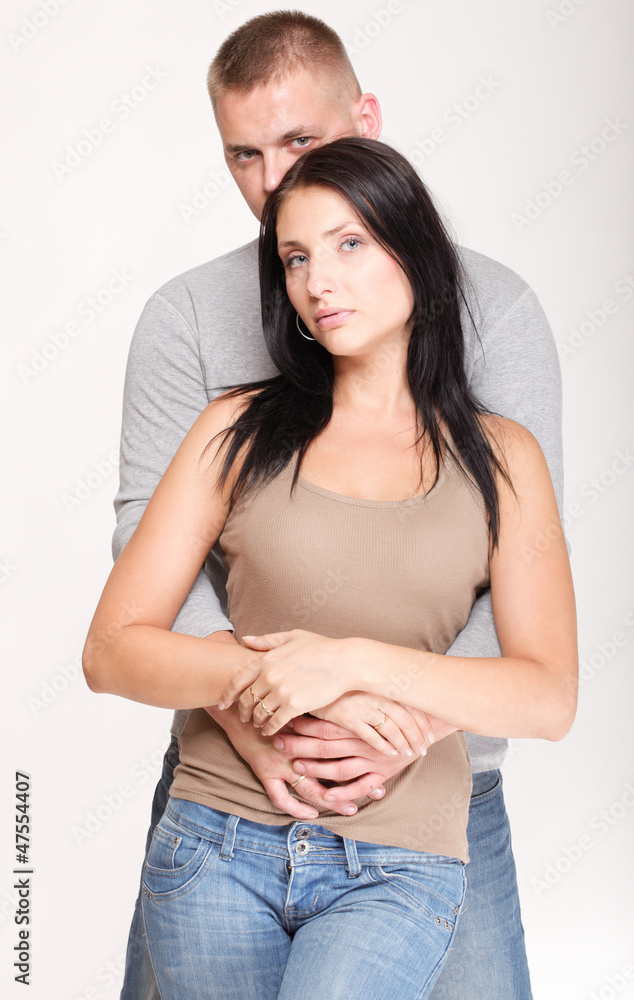 Beautiful pensive man woman stand near gray wall Beautiful pensive man woman stand near gray wall