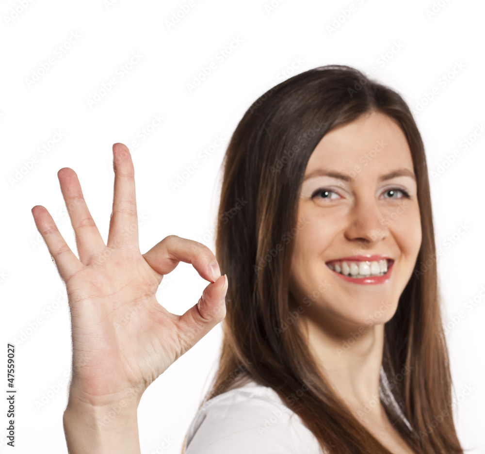 Attractive brunette shows okay. Studio white background Attractive brunette shows okay. Studio white background