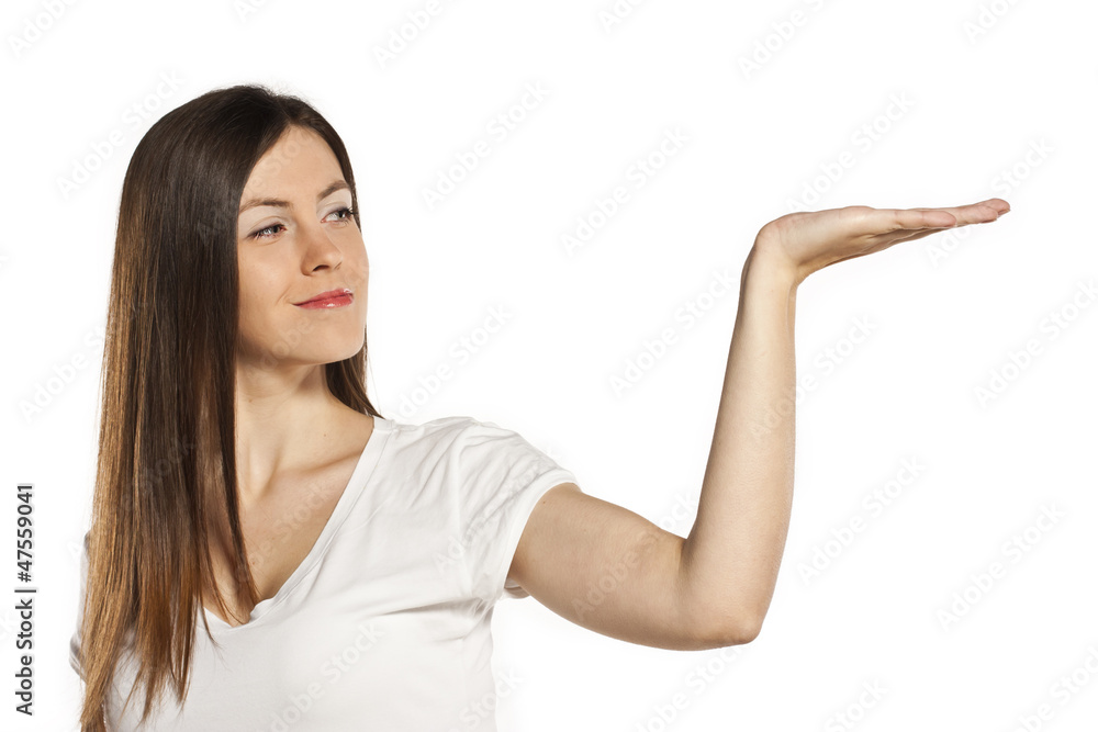 Attractive young student holding on an open hand in the studio Attractive young student holding on an open hand in the studio