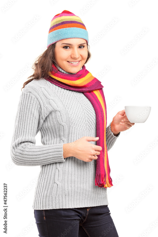 Young female with hat and scarf holding a cup of tea Young female with hat and scarf holding a cup of tea