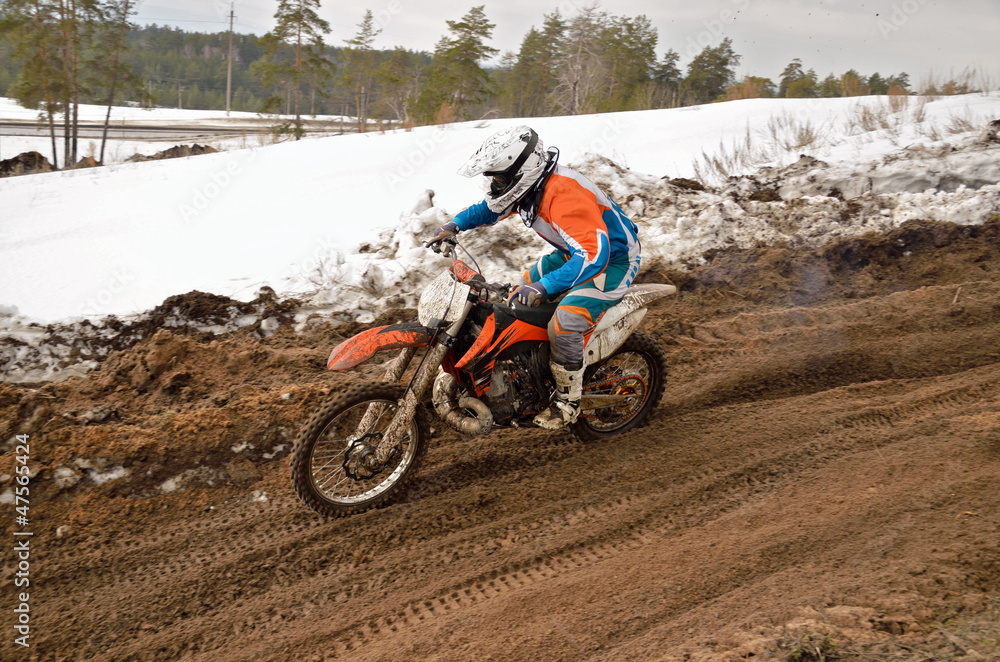 MX racer rides in descent on the motocross track MX racer rides in descent on the motocross track