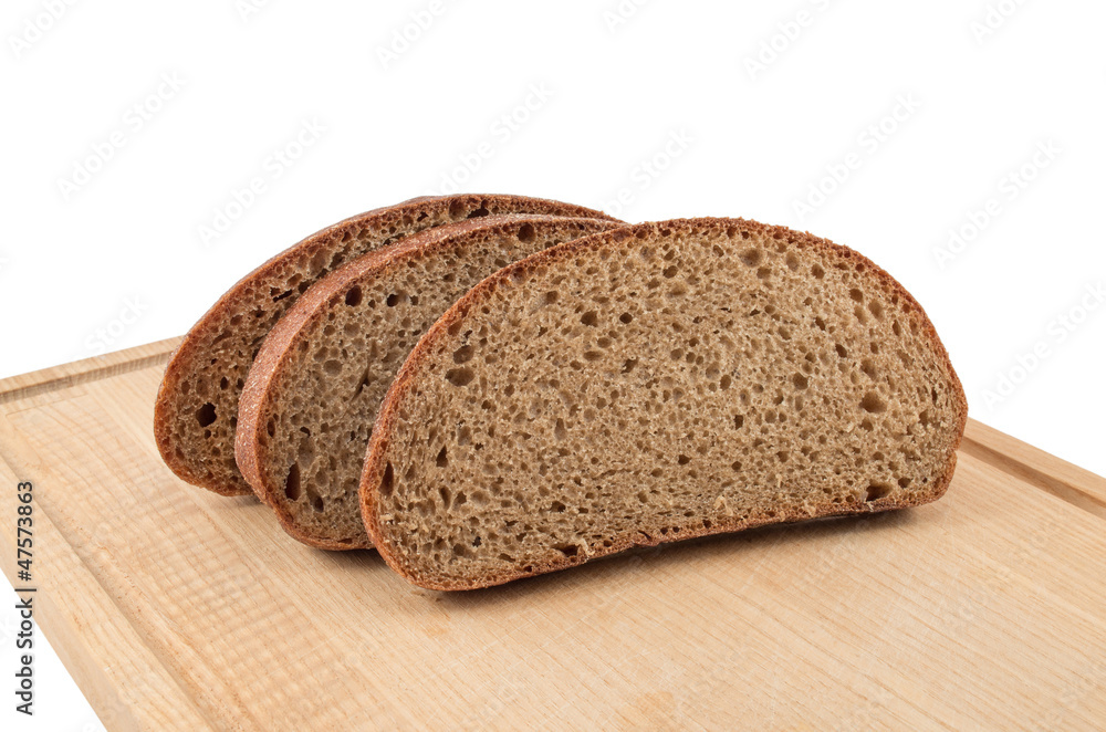 The slices bread on a chopping board The slices bread on a chopping board