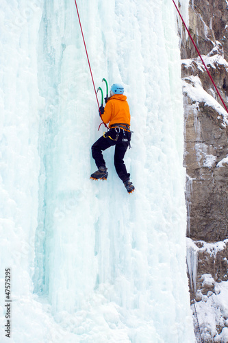 Man climbing frozen waterfall