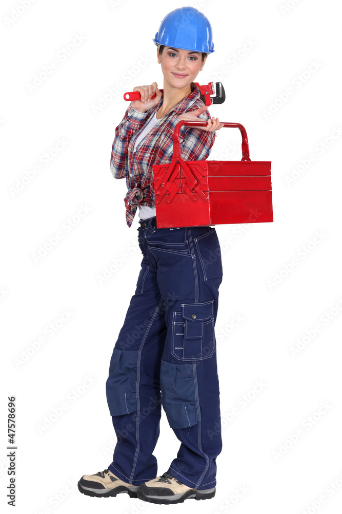 craftswoman holding a spanner and a tool box craftswoman holding a spanner and a tool box