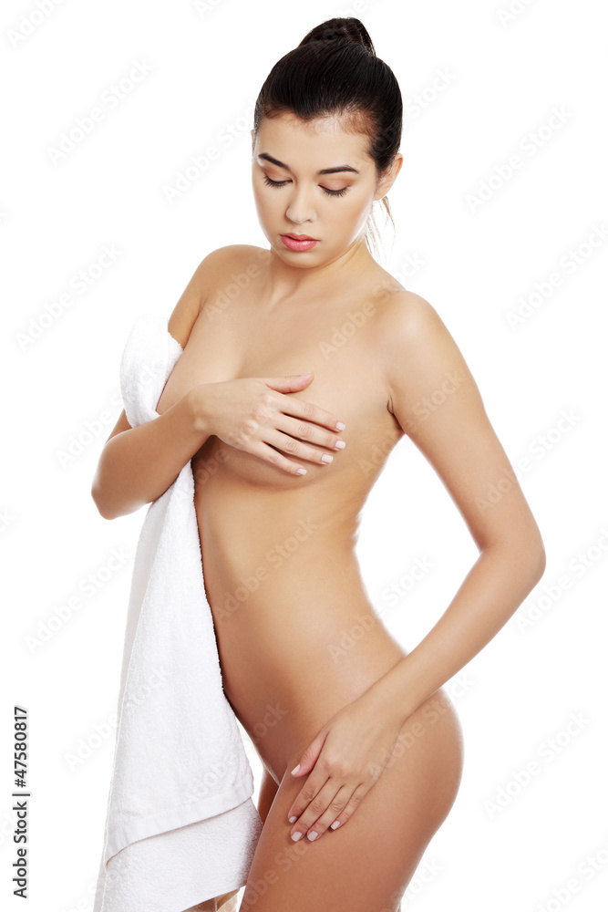 Obraz premium Young naked woman covering her self with towel