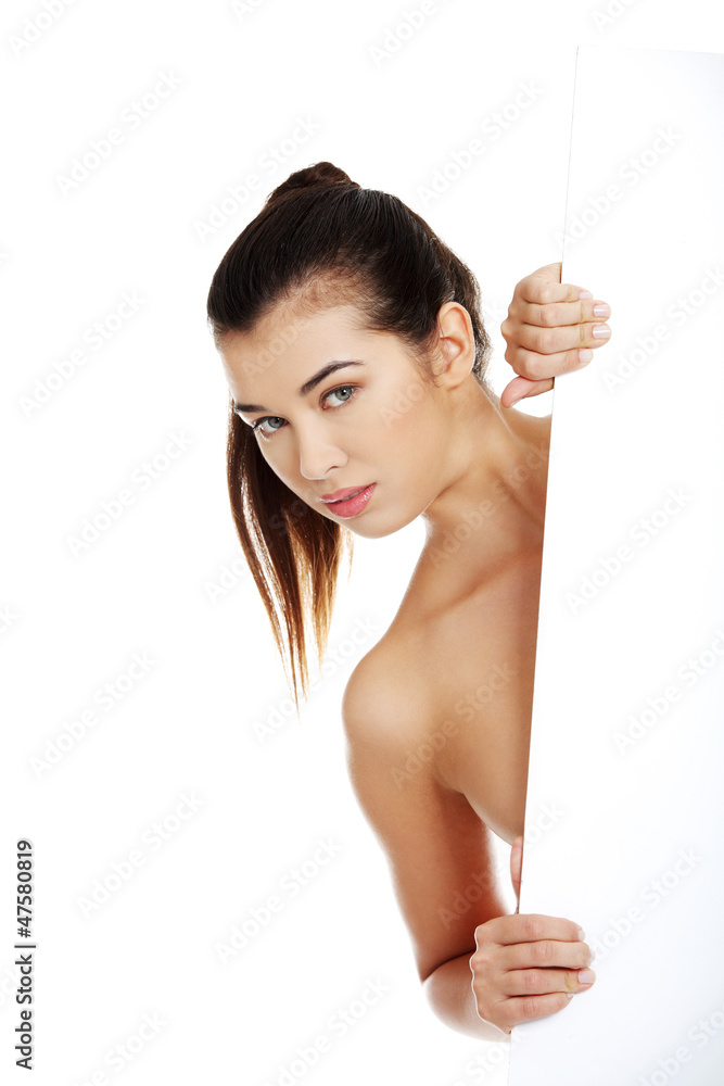 Sexy naked brunette holding empty board Sexy naked brunette holding empty board