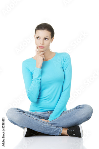 Thoughtful female student looking on side photo