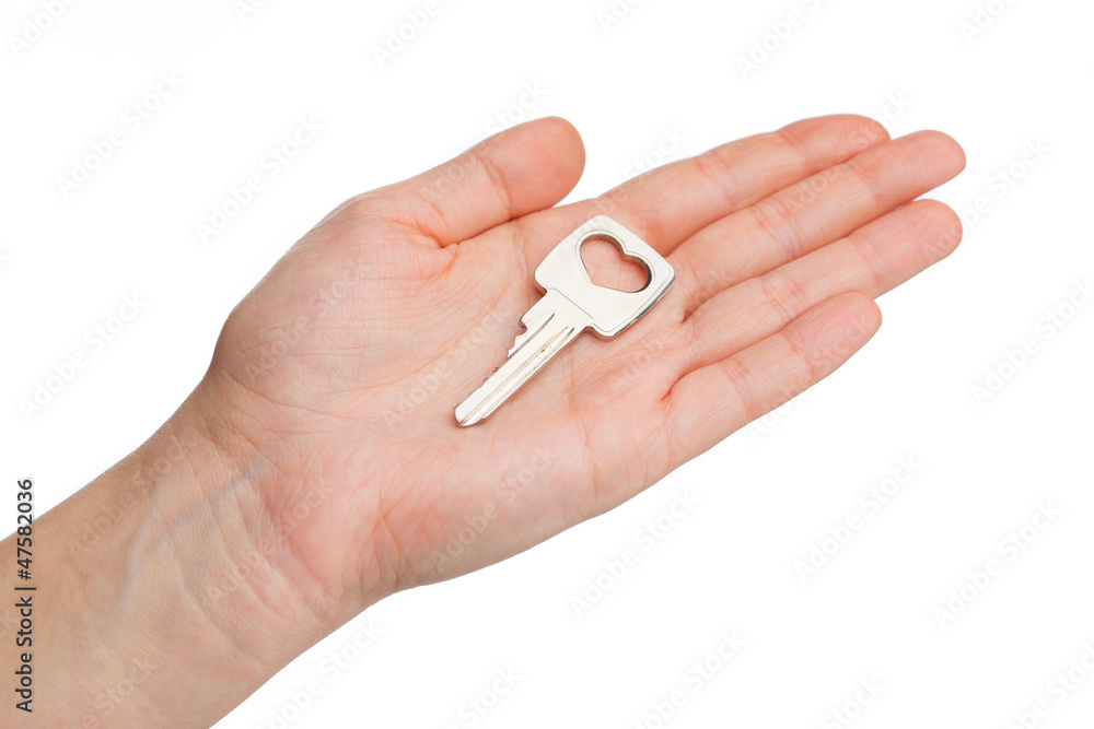 key on a human palm isolated on white