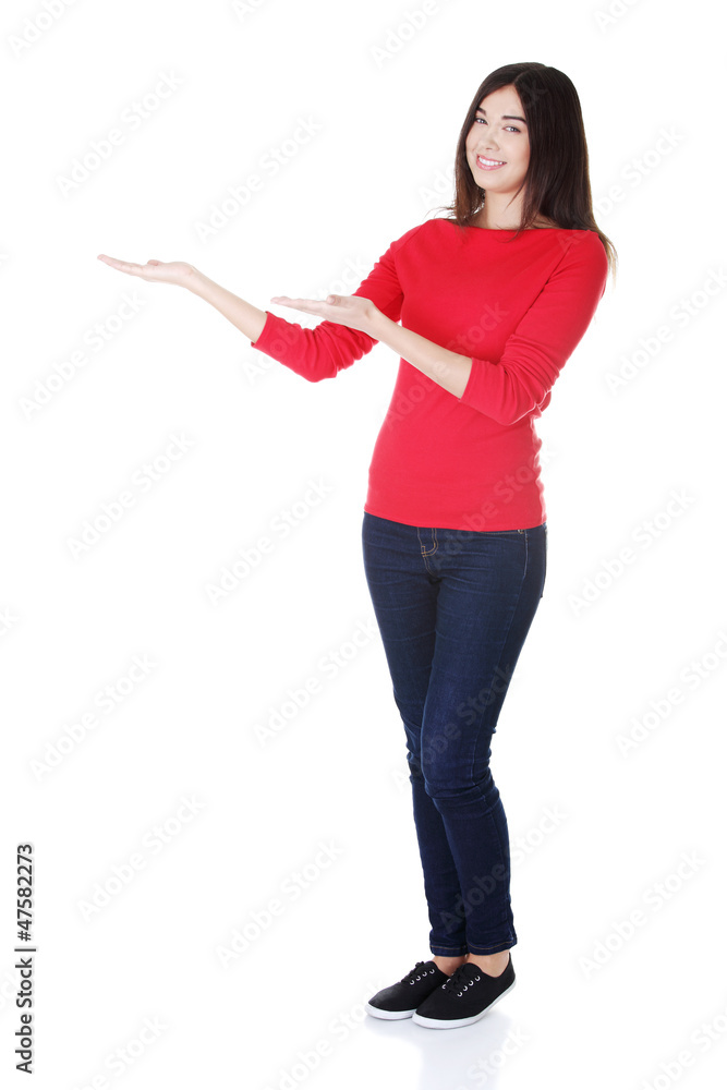 Happy woman showing something on the palm Happy woman showing something on the palm