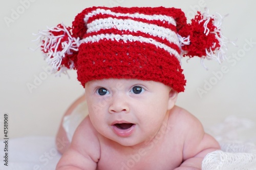 Portrait of the baby in a red knitted hat (3 months)