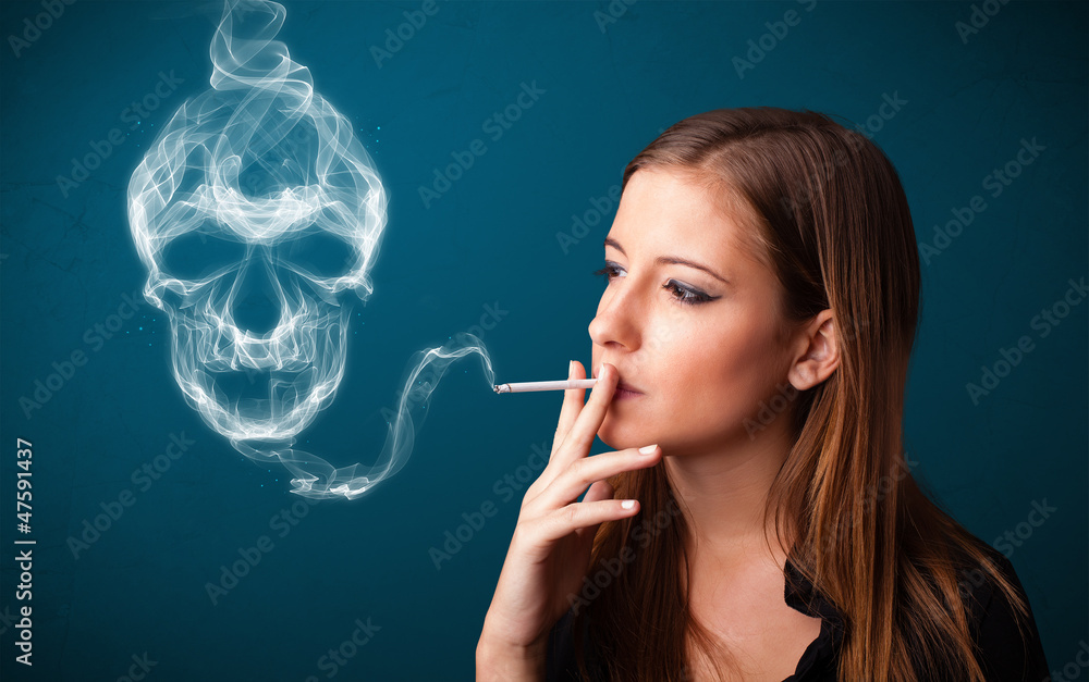 Obraz premium Young woman smoking dangerous cigarette with toxic skull smoke