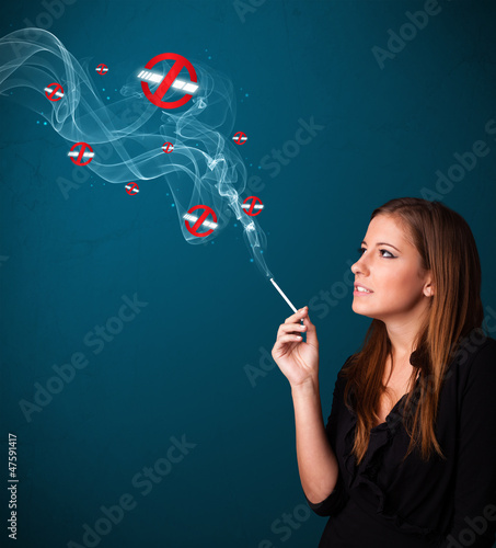 Young woman smoking dangerous cigarette with no smoking signs