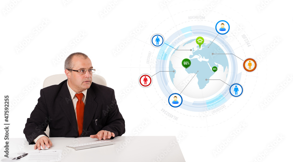 businessman sitting at desk and typing on keyboard with globe an businessman sitting at desk and typing on keyboard with globe an