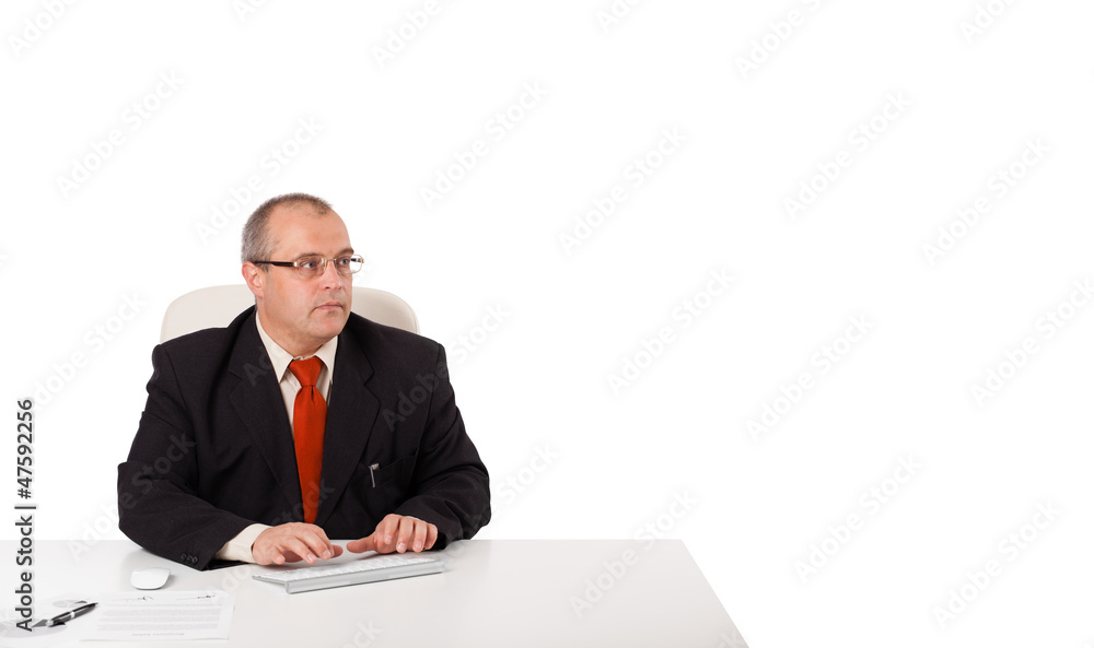 businessman sitting at desk and typing on keyboard with copy sca businessman sitting at desk and typing on keyboard with copy sca