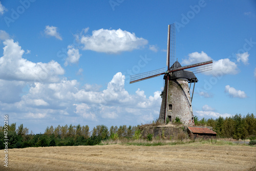 Old windmill on cloudy sky