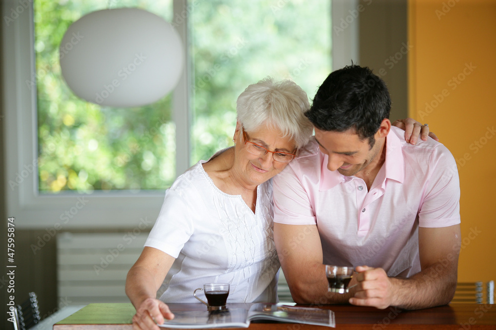 Senior woman drinking coffee with her son Senior woman drinking coffee with her son