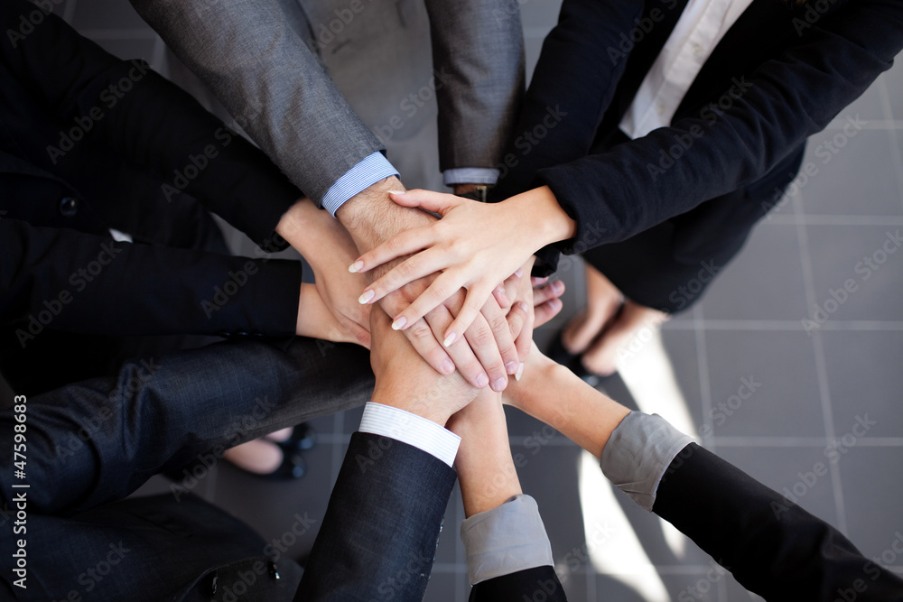 © baranq - Business team joining hands