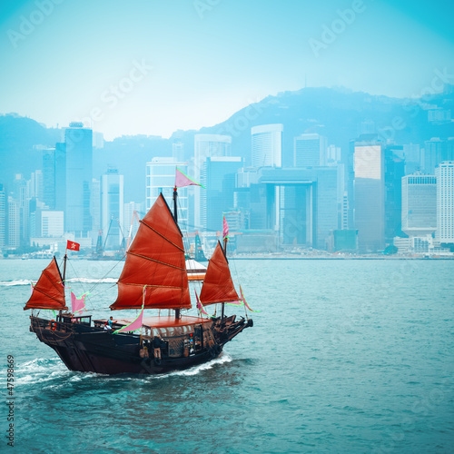 traditional wooden sailboat sailing in victoria harbor