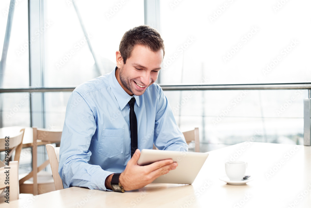 Businessman with digital tablet smiling