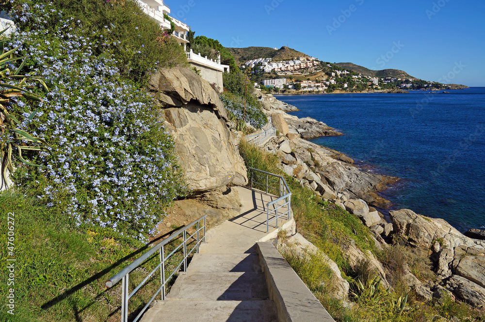 Coastal footpath along the Mediterranean sea in Rosas, Costa Brava, Catalonia, Spain