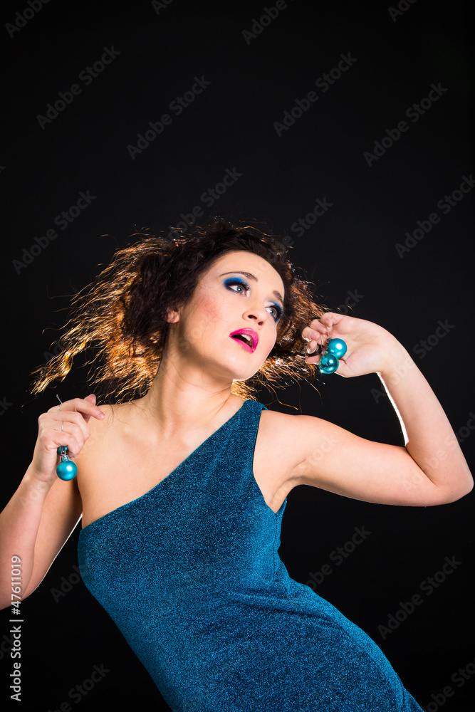 Naklejka premium beautiful girl playing with Christmas decoration