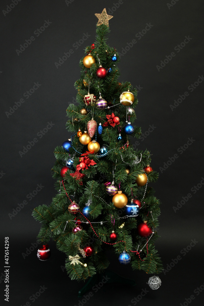 Decorated Christmas tree isolated on black