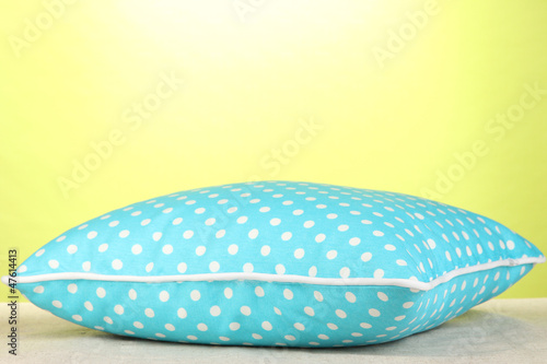 Blue bright pillow on green background © Africa Studio