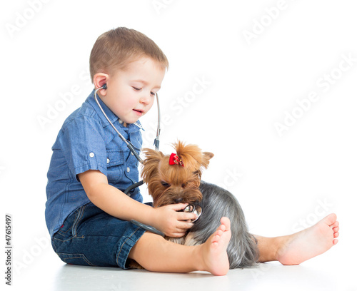 boy child examing dog puppy...