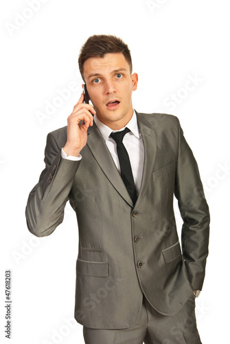 Businessman amazed by a phone call