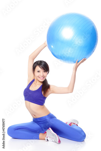 Woman holding fitness ball up