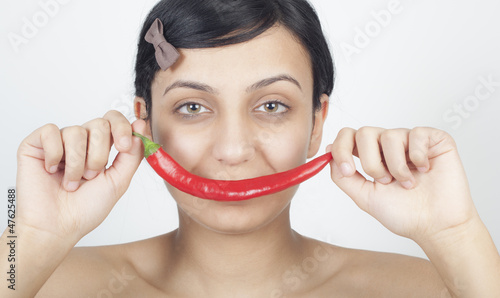 Beautiful girl with chili