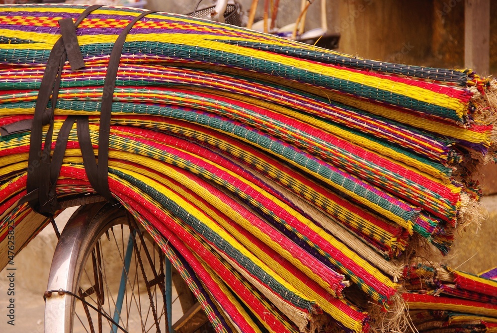 Colorful straw mats on the lugage carrier of a bicycle Colorful straw mats on the lugage carrier of a bicycle