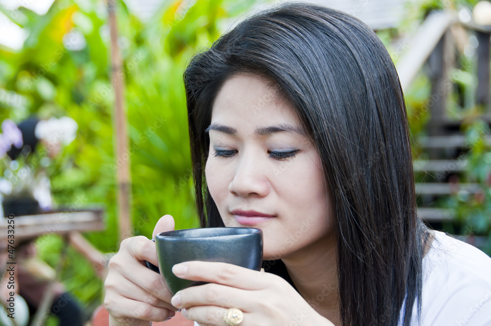 Beautiful asian woman with a cup of coffee. Beautiful asian woman with a cup of coffee.